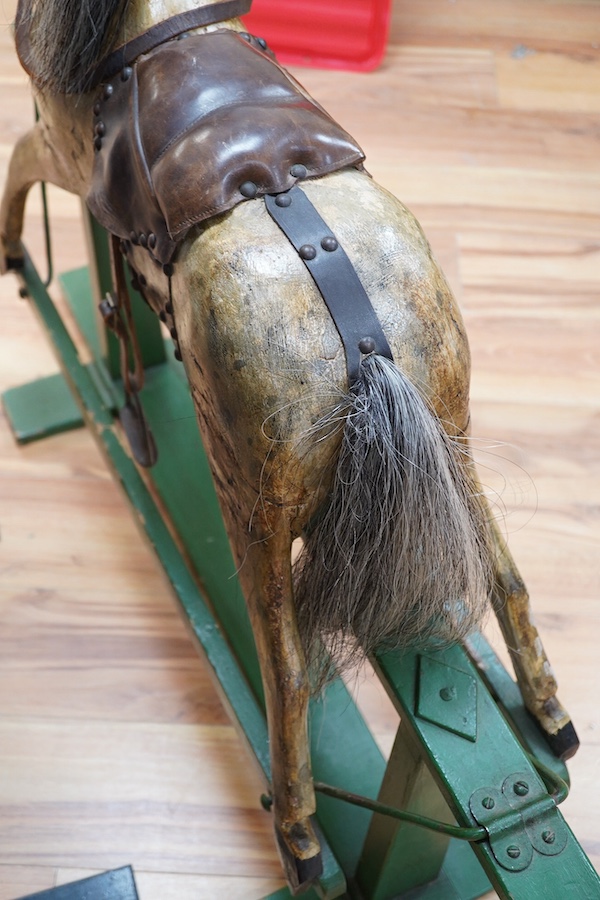 An early 20th century small dapple grey rocking horse, 92cm high, 112cm long. Condition - fair